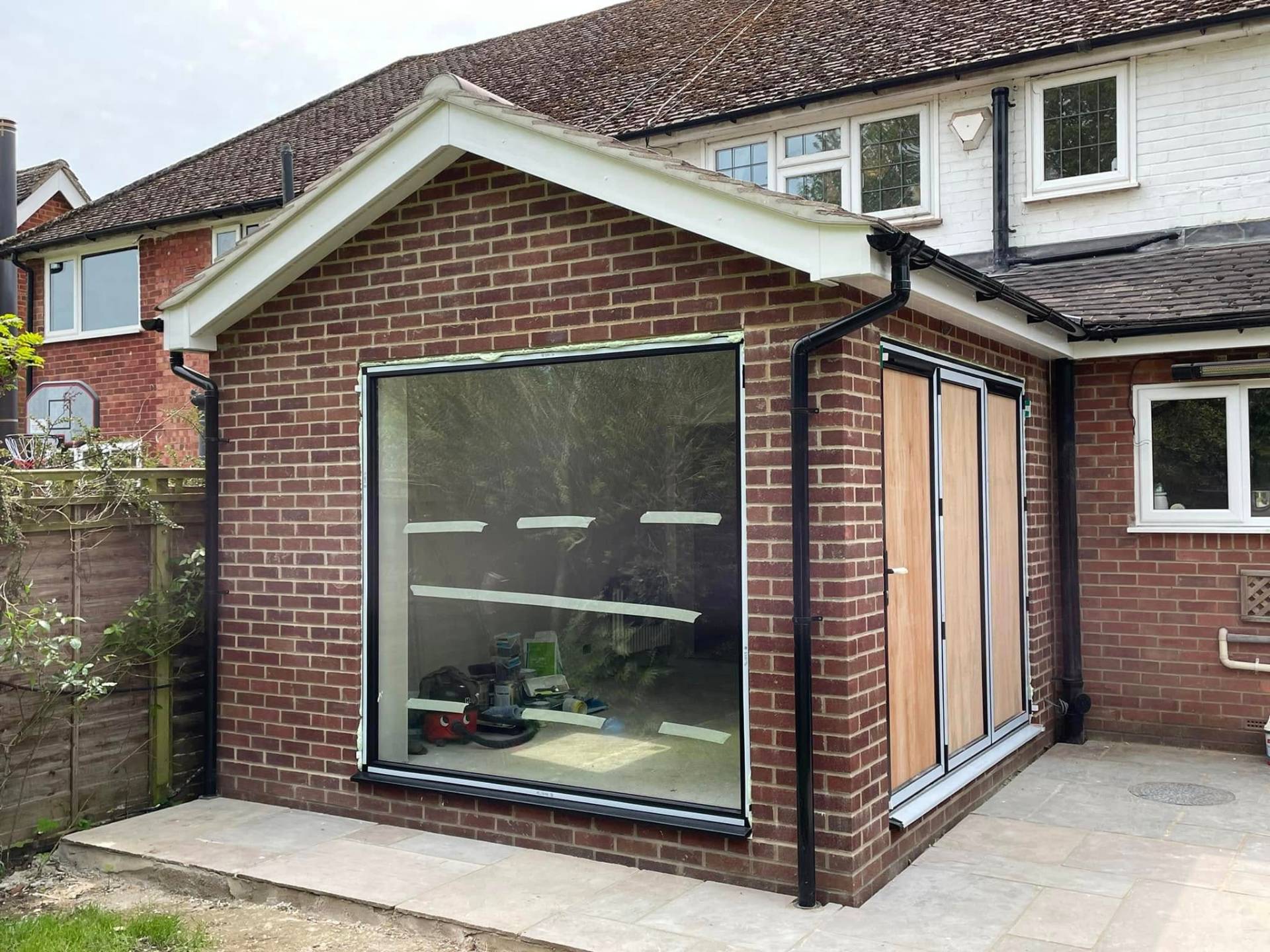 Completed brick house extension with large windows