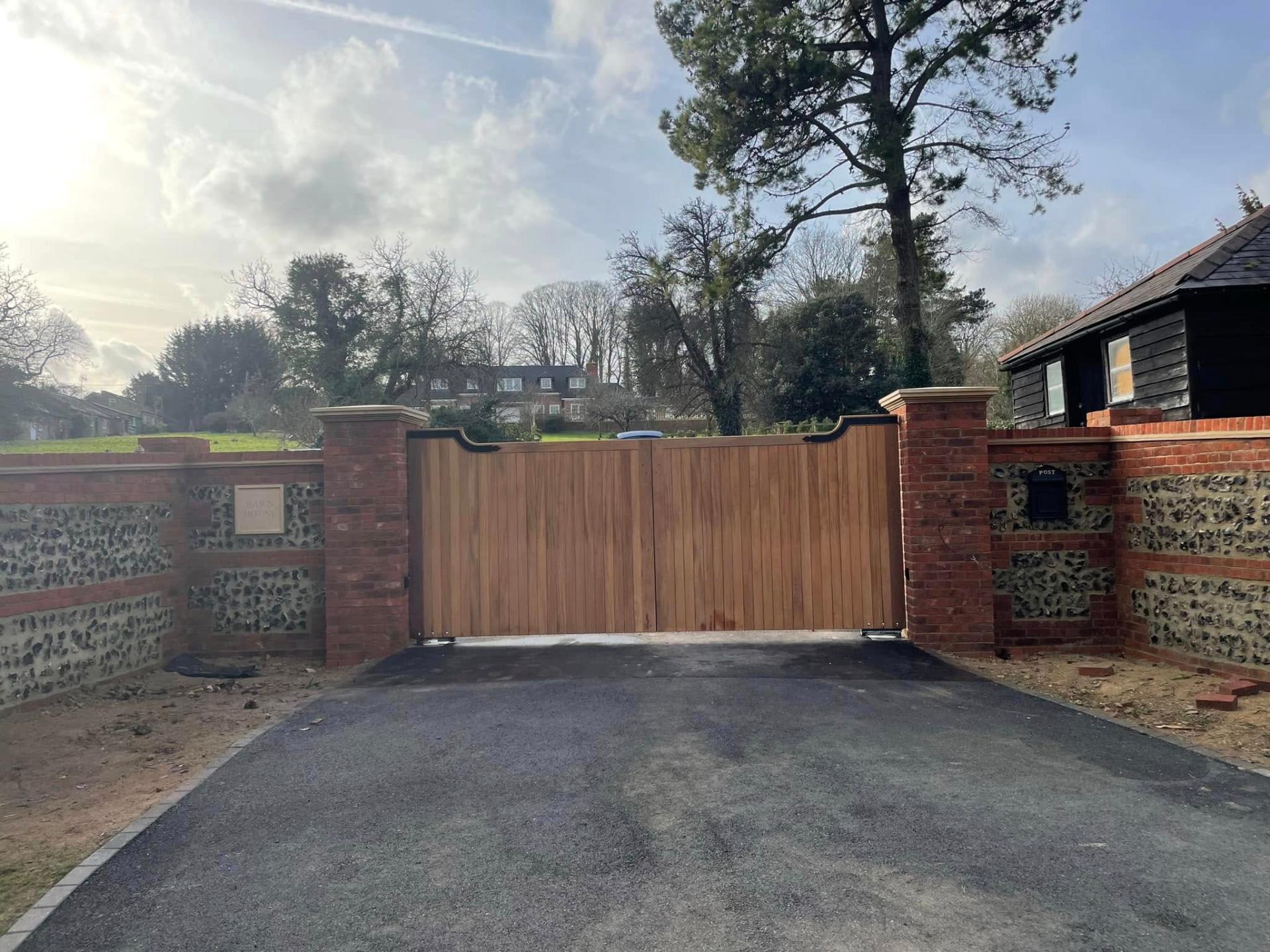 new tarmac driveway with wooden gates — Philbert Construction driveways project in Reading