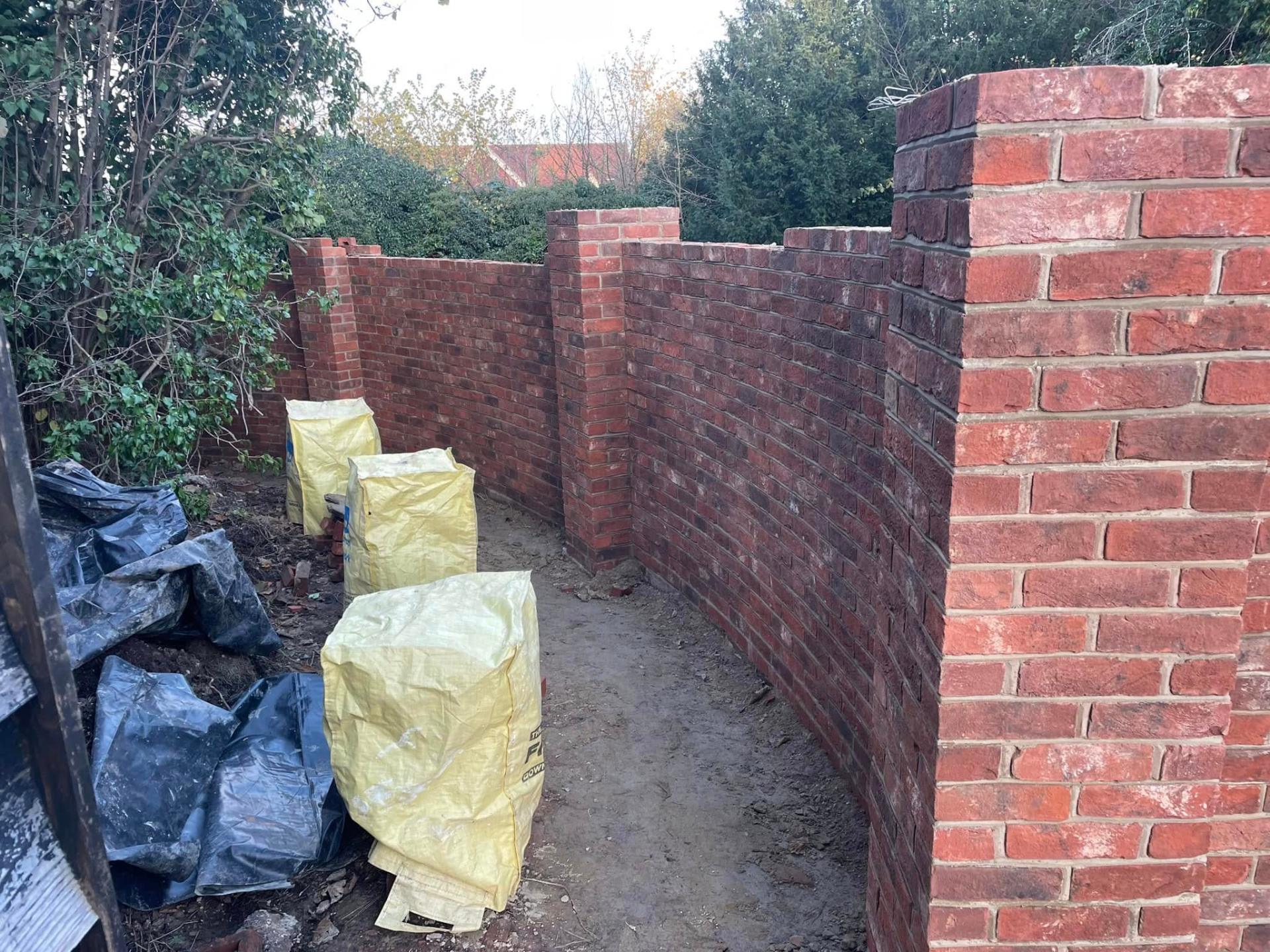 Newly built red brick wall with pillars — Philbert Construction brickwork project in Reading