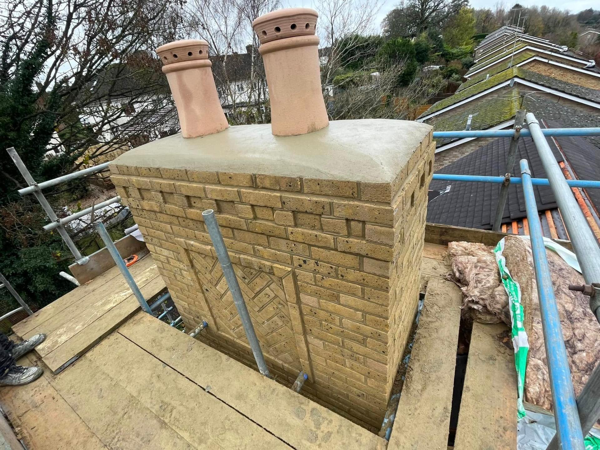 Chimney stack construction on a roof — Philbert Construction roofing project in Reading