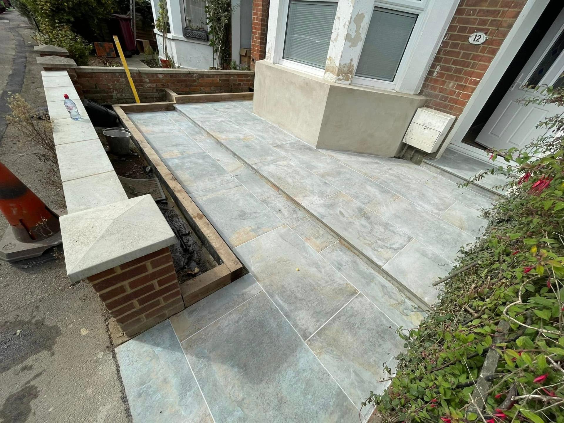 Stone patio/driveway with brick wall — Philbert Construction driveways project in Reading
