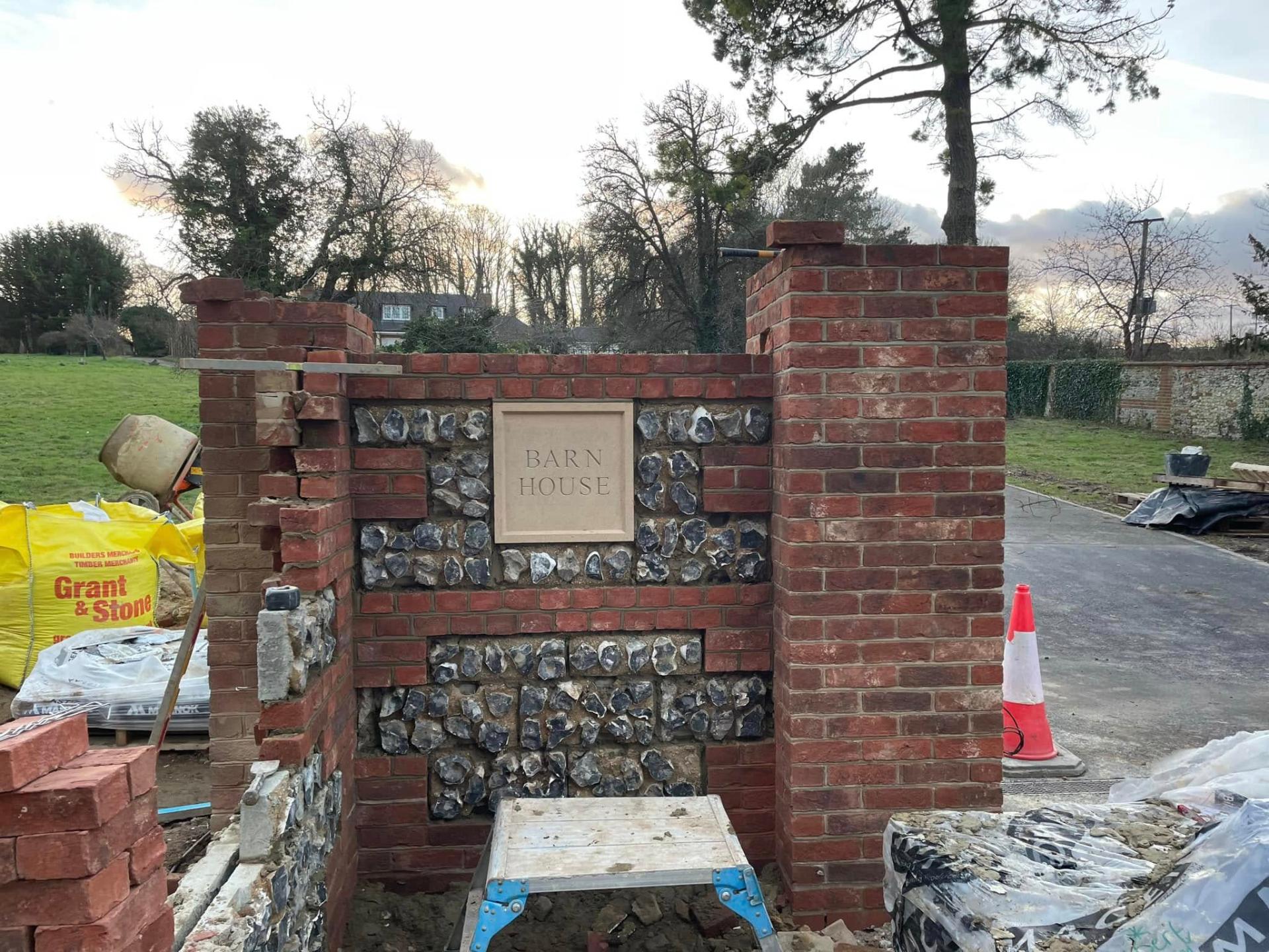 brick and flint wall with house sign — Philbert Construction brickwork project in Reading